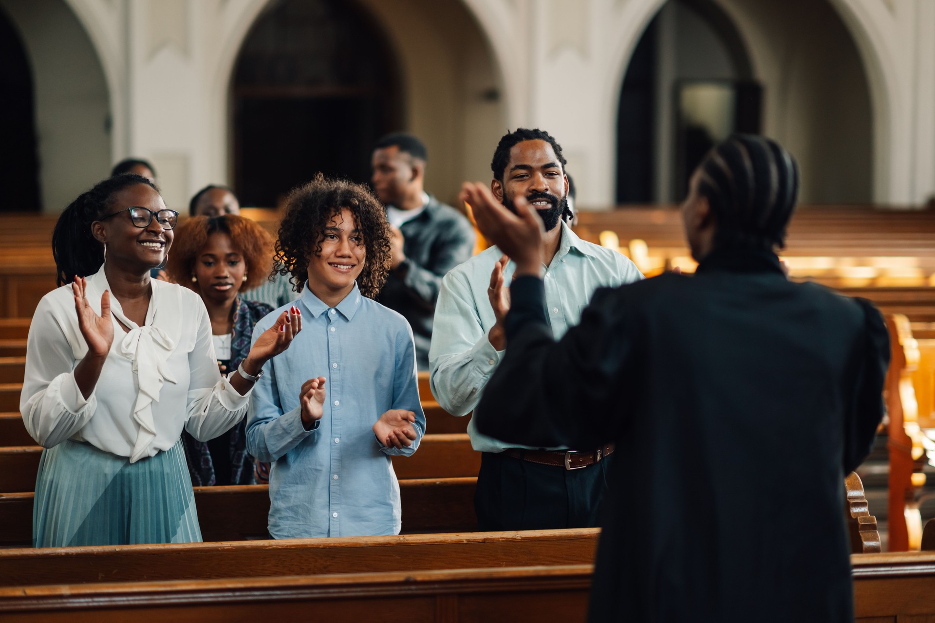 Congregation clapping along with preacher in church